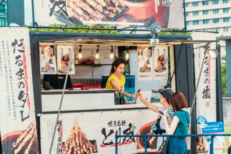 Why Coachella’s Celebrity Chef Pop-Ups Are Replacing Traditional Food Vendors Outdoor festival food vendor setup with people dining at tables under tents