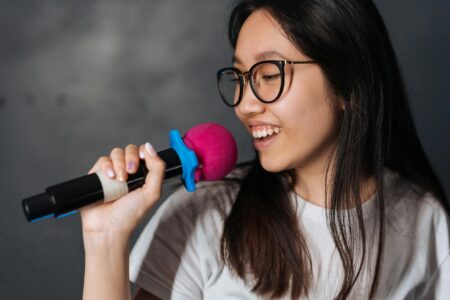 Professional microphone in dimly lit karaoke venue with stage lights