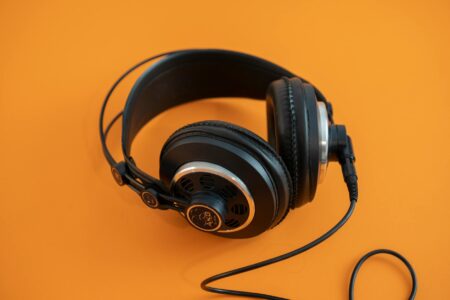 Person wearing headphones listening to music on smartphone