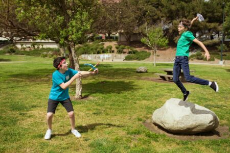 Adults participating in outdoor camp activities at summer retreat