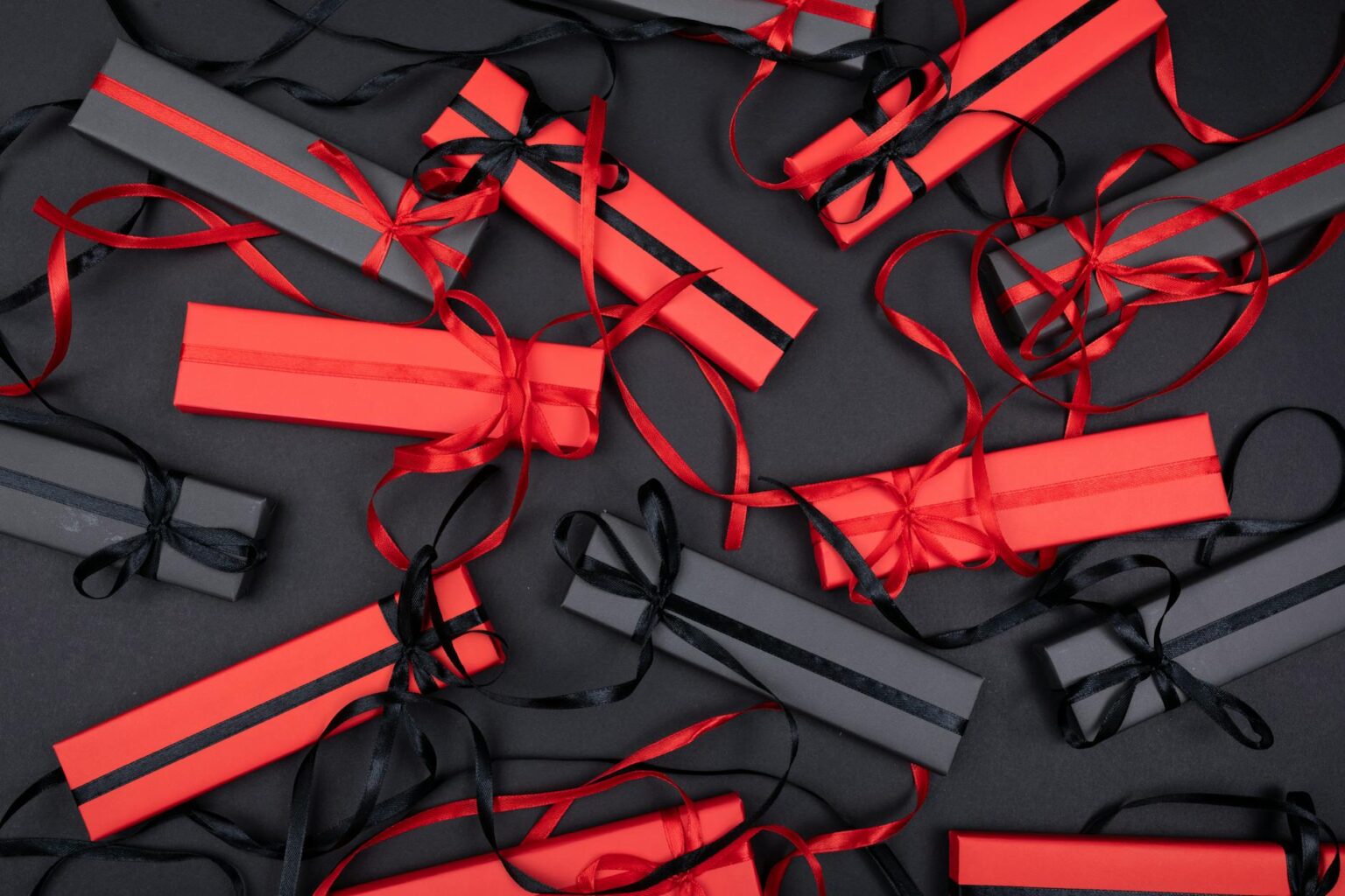 Elegant gift boxes with ribbons and decorative paper showing professional wrapping techniques