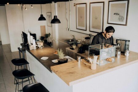 The Rise of Silent Coffee Shops Catering to Remote Workers Modern coffee shop interior with individual workstations and quiet atmosphere