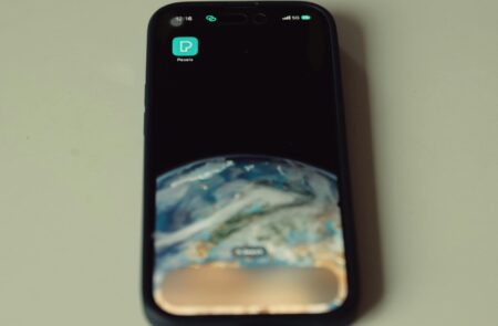 Person holding smartphone in vertical orientation displaying video content