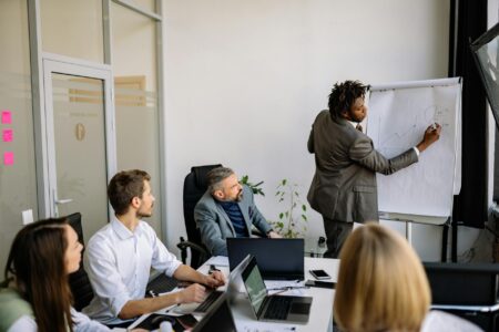 Why Corporate Volunteer Days Are Just PR Theater for Employees Business professionals in corporate meeting room discussing volunteer initiatives