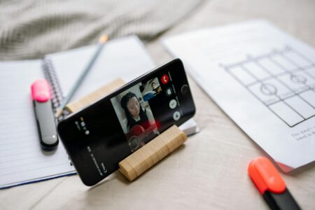 How Duolingo’s Gamification Strategy Is Reshaping Language Learning Habits Person using language learning app on smartphone with colorful interface