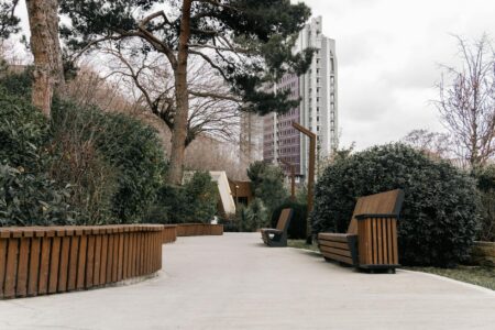 Underground Foraging Classes Are Teaching Urban Millennials Ancient Food Skills People exploring an urban park setting with trees and pathways