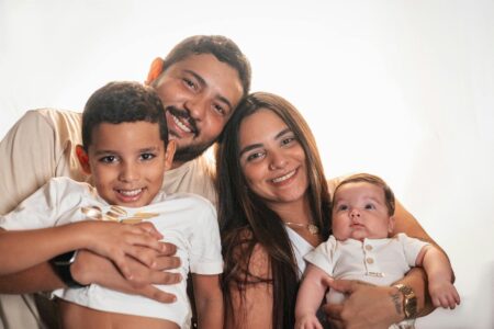 Why Millionaire Parents Are Hiring Professional Childhood Documentation Services Professional photographer taking pictures of a family in a bright, modern home setting
