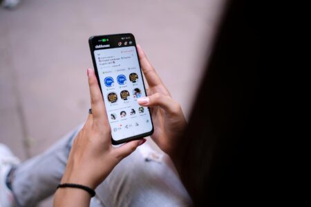 Celebrity Mental Health Advocacy Is Just Performative Wellness for Personal Branding Person holding smartphone displaying social media interface with wellness content