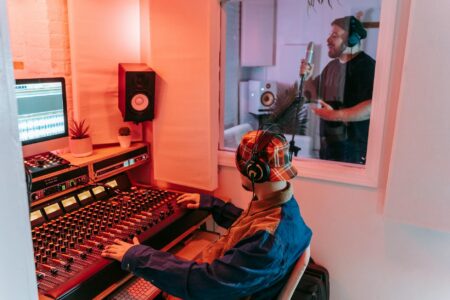 Professional music recording studio with mixing board and microphones