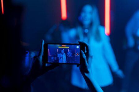 Person holding smartphone recording vertical video content