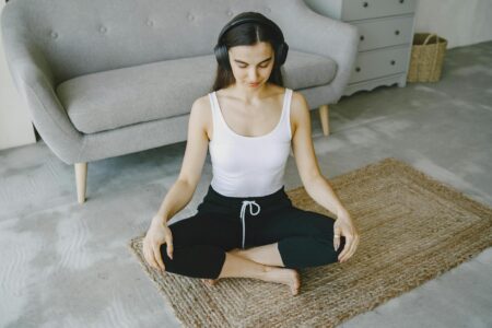Cozy meditation corner with cushions and soft lighting in a small enclosed space