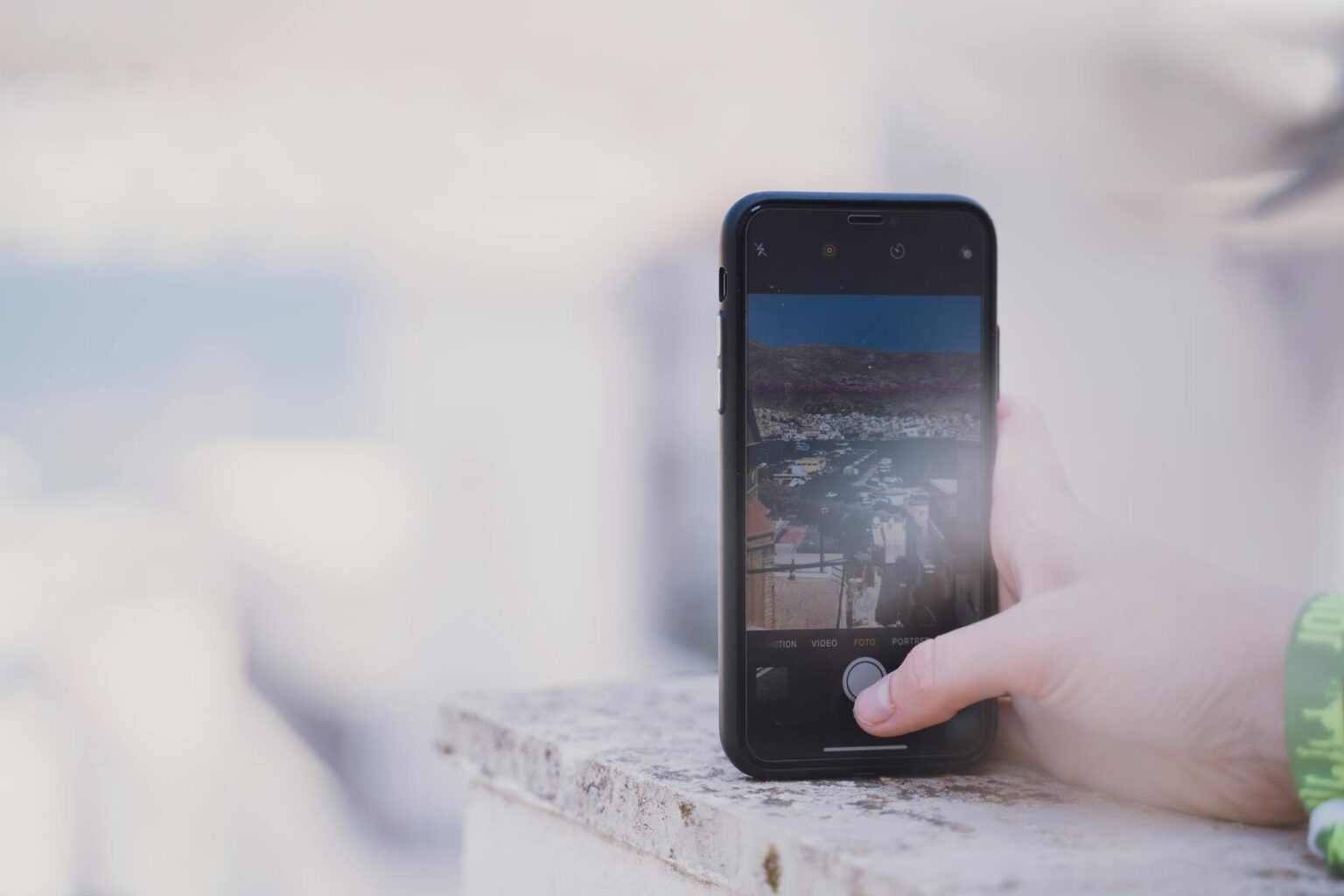 The Growing Trend of Hiring Personal Archivists for Digital Photos Close-up of smartphone screen displaying photo gallery with multiple thumbnail images