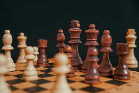 Why Chess Clubs Are Having Their Biggest Renaissance Since Netflix Chess pieces arranged on wooden board showing strategic gameplay