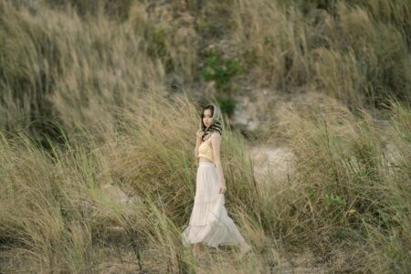 White Maxiskirts Dominate Summer Fashion From Coachella to Corporate Offices Woman wearing flowing white maxiskirt in summer setting
