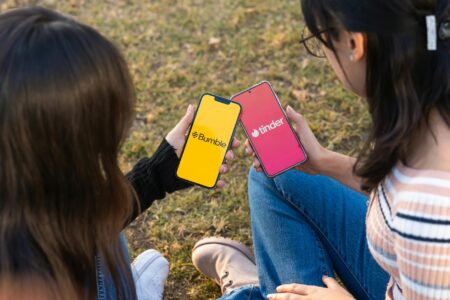 Bold Pickup Lines Replace Basic Openers in Modern Dating Person using dating app on smartphone with message interface visible