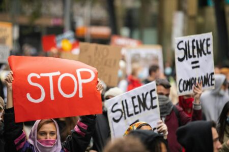 Jeff Bezos Met Gala Sponsorship Ignites Worker Rights Protests Activists holding protest signs during street demonstration