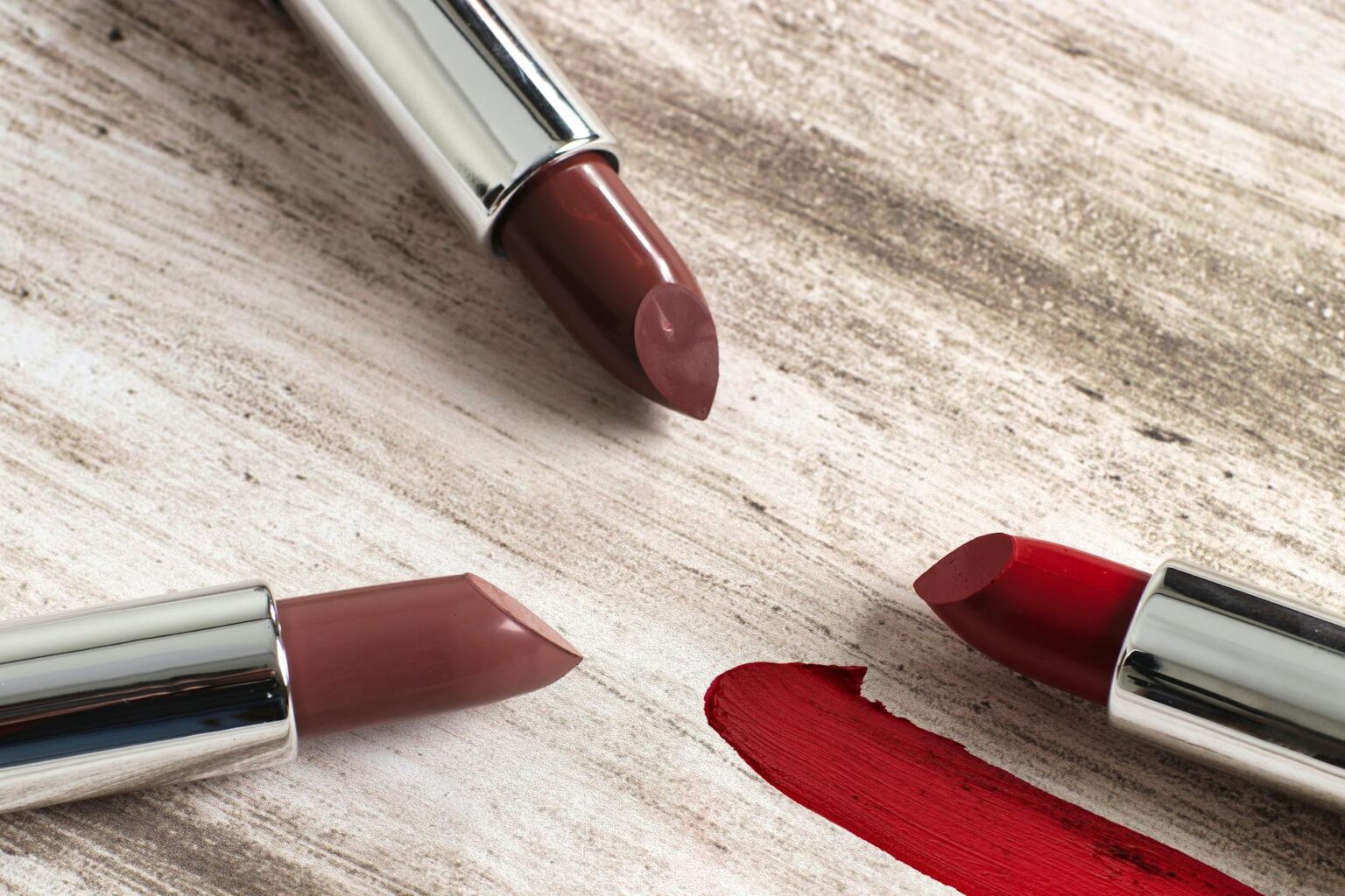 Close-up of natural nude lipstick application on lips