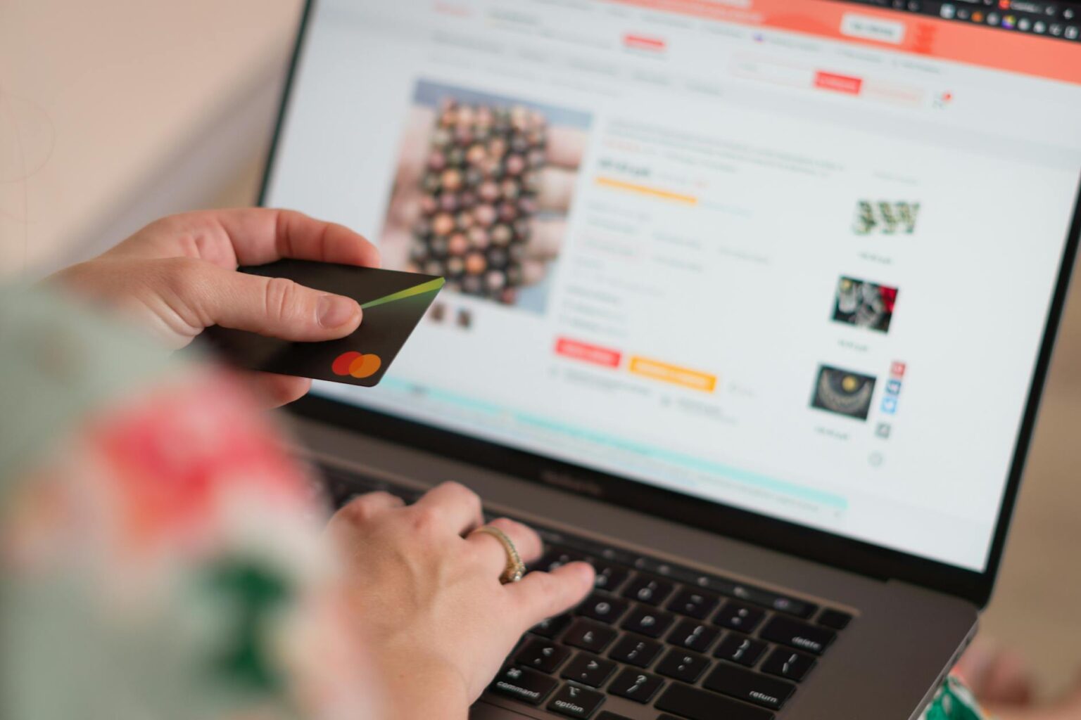 Person browsing products on laptop screen showing various retail websites
