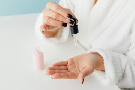 Marine Sponge Needles Promise At-Home Microneedling Alternative Person applying facial serum with dropper