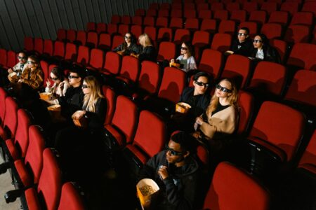 Devil Wears Prada Sequel Breaks the Curse After 20 Years Dark movie theater with illuminated screen