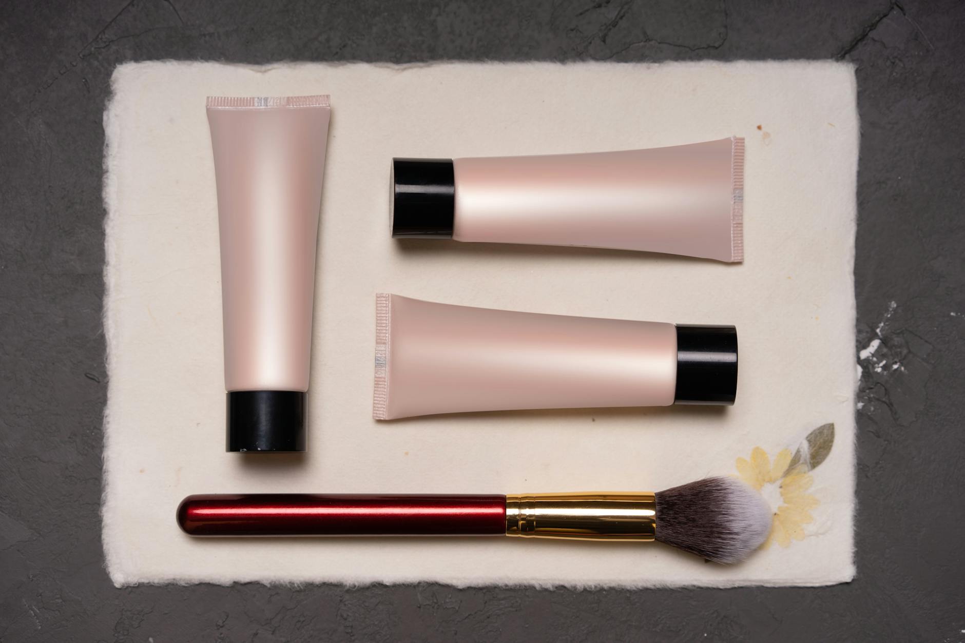 Assorted beauty and skincare products laid out on a clean white background