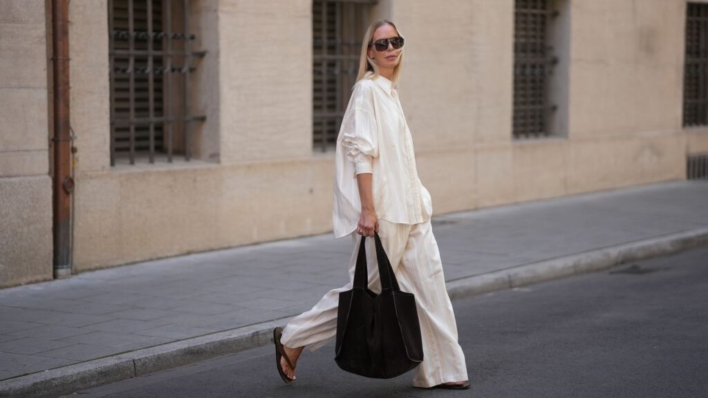 Person styling comfortable pants with blazer for daytime look