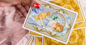 Junes Tarot Cards Say Youre Still Waiting to Feel Good Woman sitting in warm summer sunlight with eyes closed, face relaxed