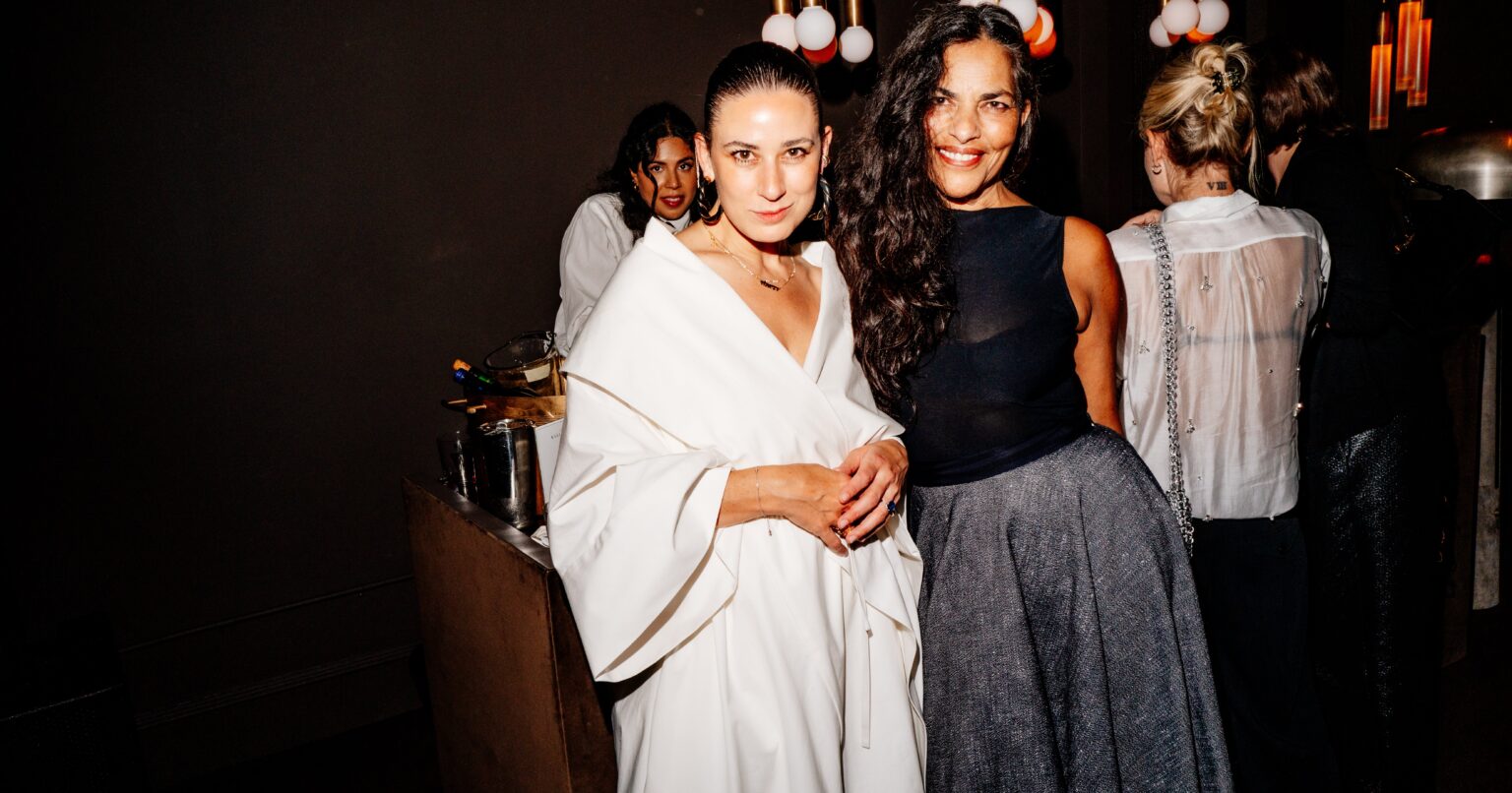Guests in stylish outfits at an intimate evening birthday party