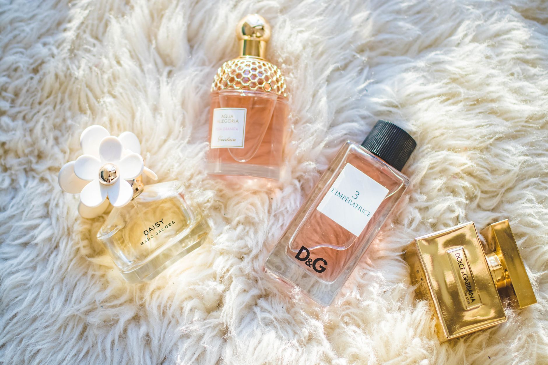 A curated collection of luxury fragrance bottles on a marble surface