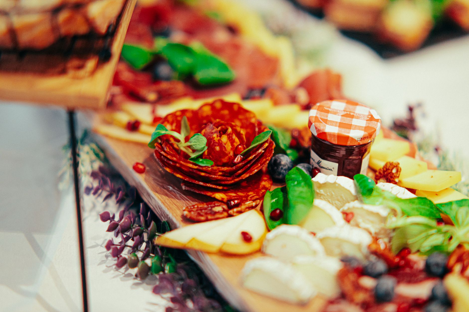 Charcuterie board and casual finger foods laid out for a party spread
