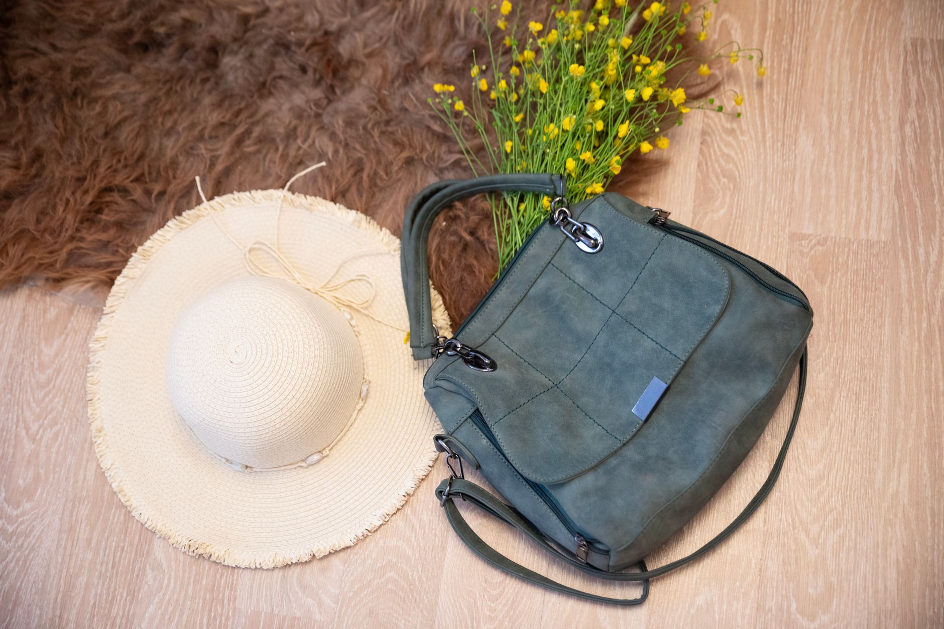 Stylish summer accessories arranged on a neutral background