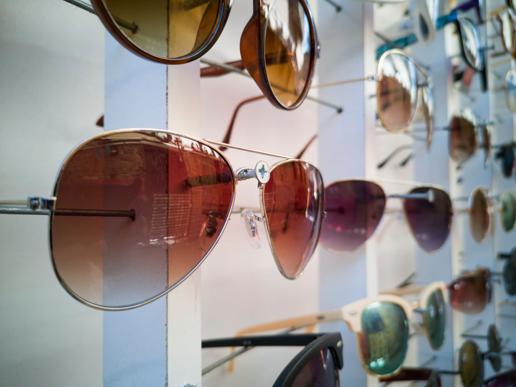 Close-up of designer sunglasses arranged on a minimalist surface