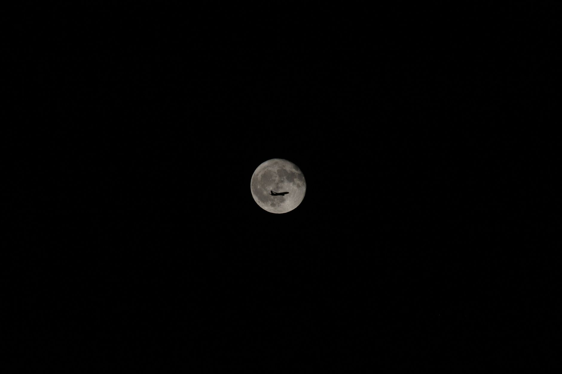 Bright full moon glowing against a dark sky