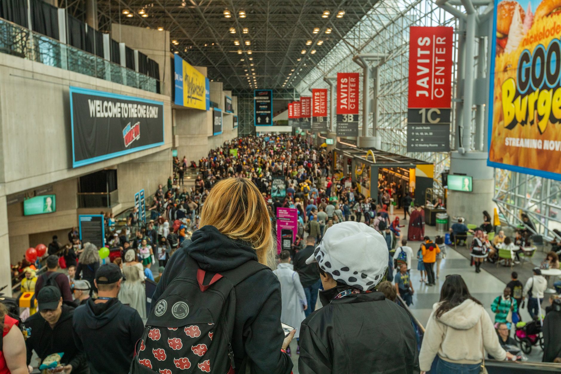 Attendees browsing vendor booths inside a busy convention center