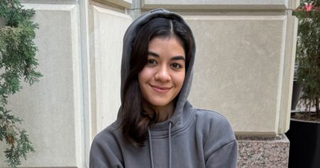 Person wearing a grey hoodie in a relaxed travel setting