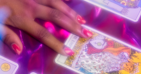 Tarot cards spread on a wooden table in soft natural light
