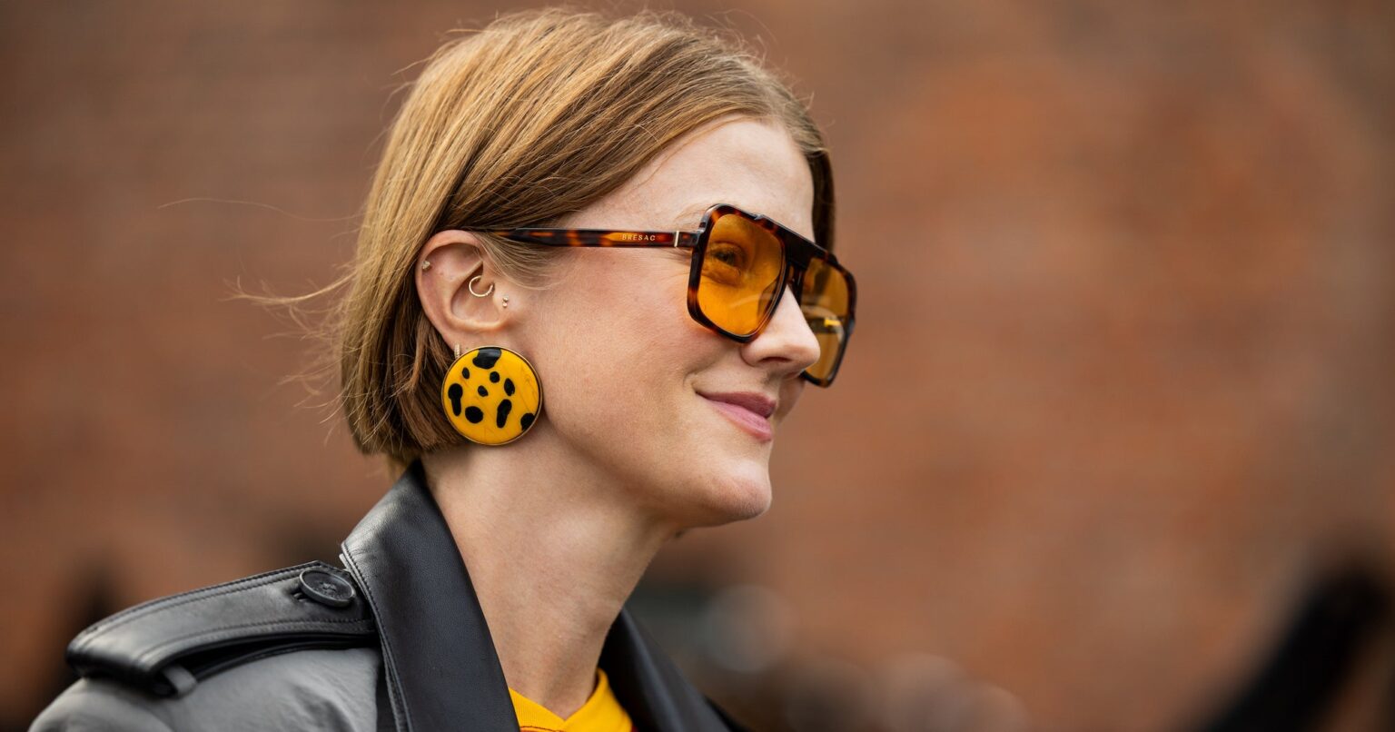 Copenhagen Fashion Week Spring 2027 Showcases the Biggest Haircut Trends A fashion week attendee with layered hair styled with volume and movement