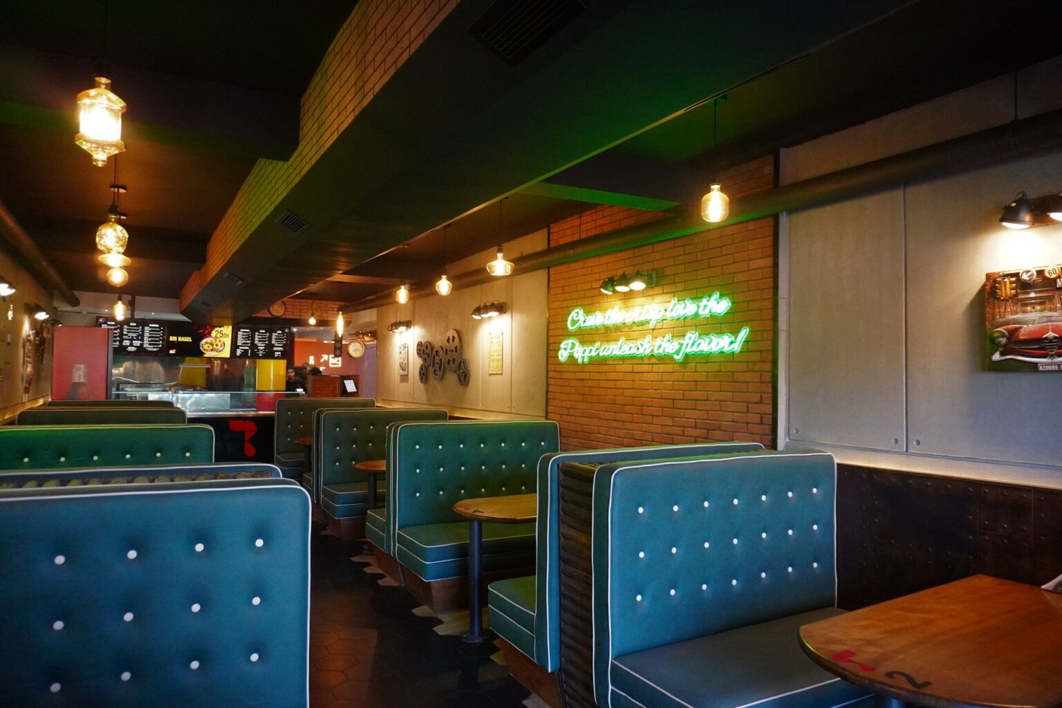 Empty fast food restaurant booth with overhead lighting, evoking the casual intimacy of a low-key interview setting