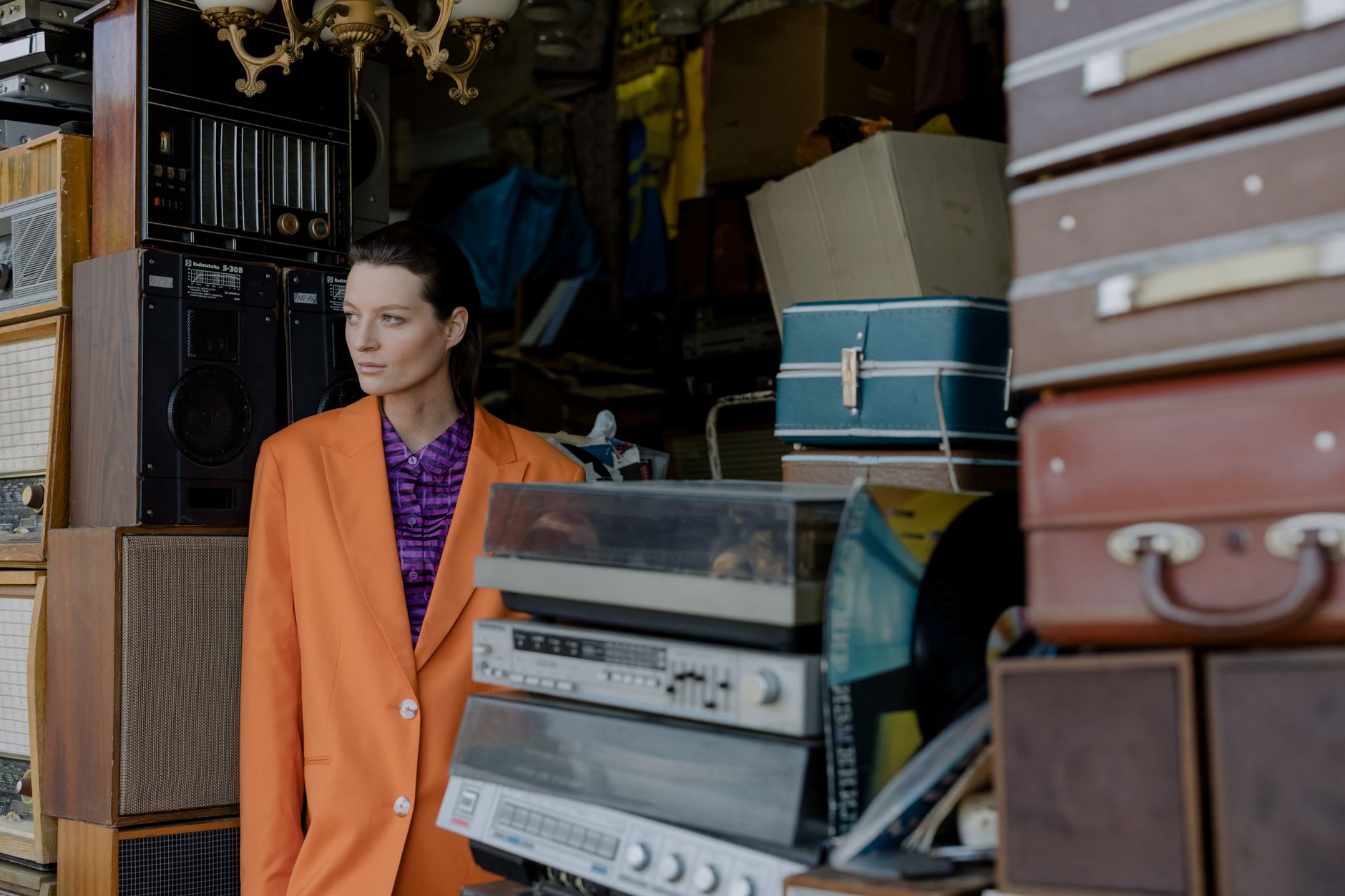 A woman in a puff-sleeve mini dress styled with accessories in a vintage-inspired look