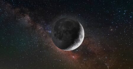 Full moon photographed against a dark blue night sky with visible stars