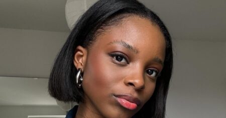 Woman with a sharp chin-length bob haircut in a salon setting