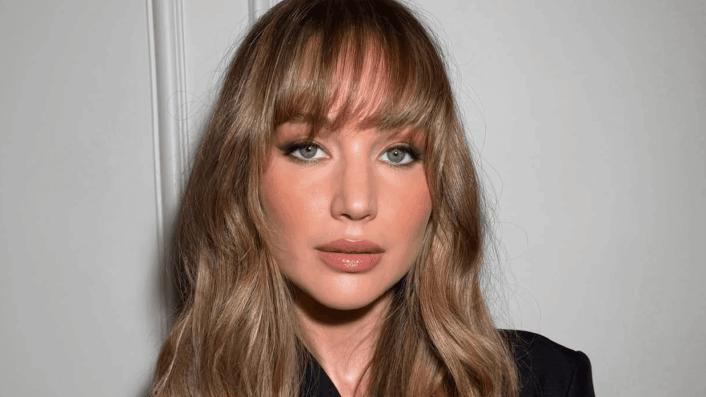 Woman with soft butterfly bangs styled outward framing her face