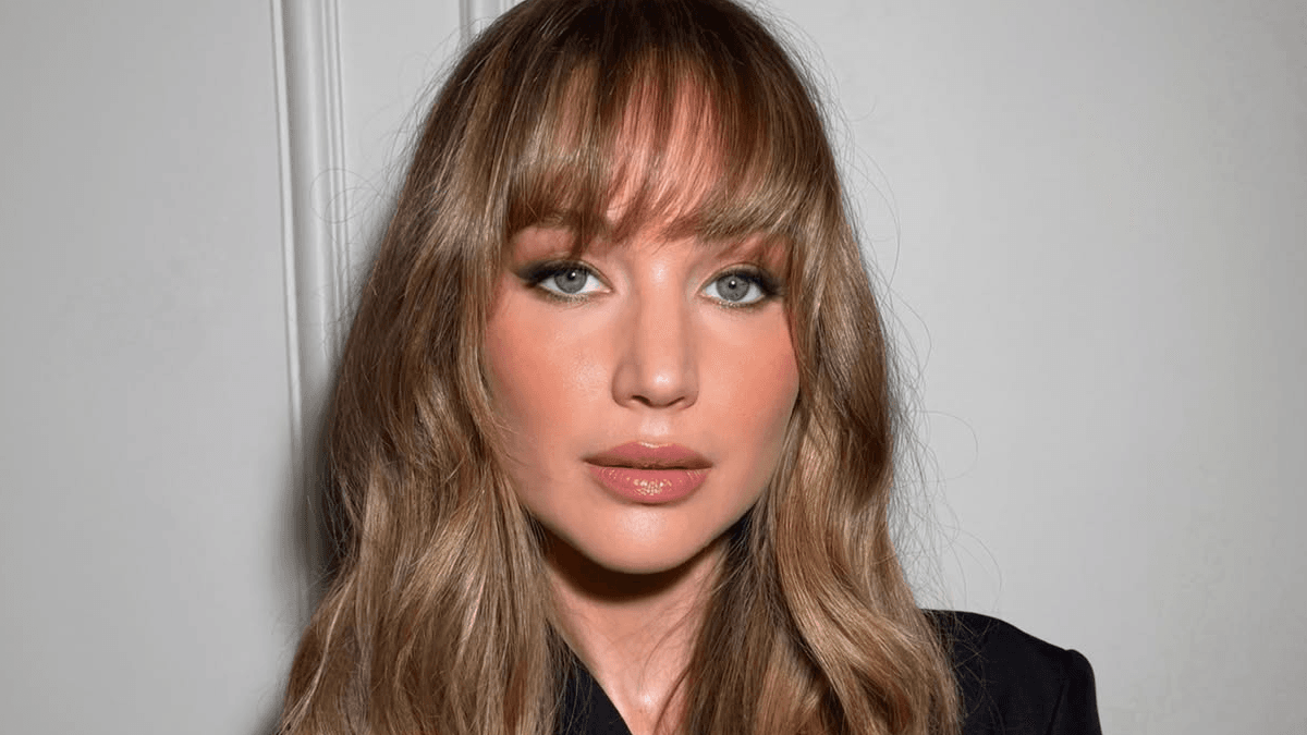 Woman with soft butterfly bangs styled outward framing her face