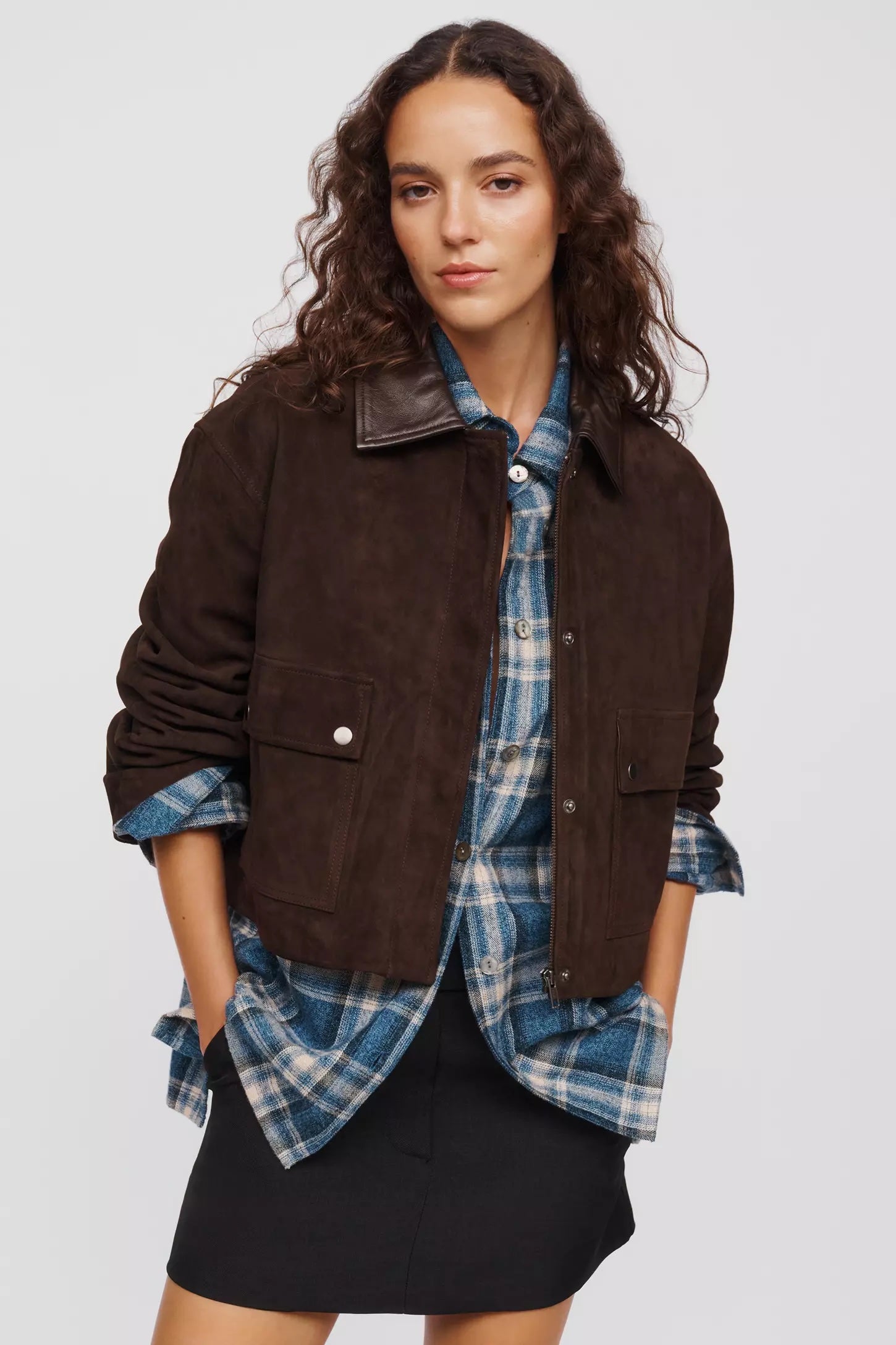 Street style outfit with layered jacket and denim during autumn fashion week