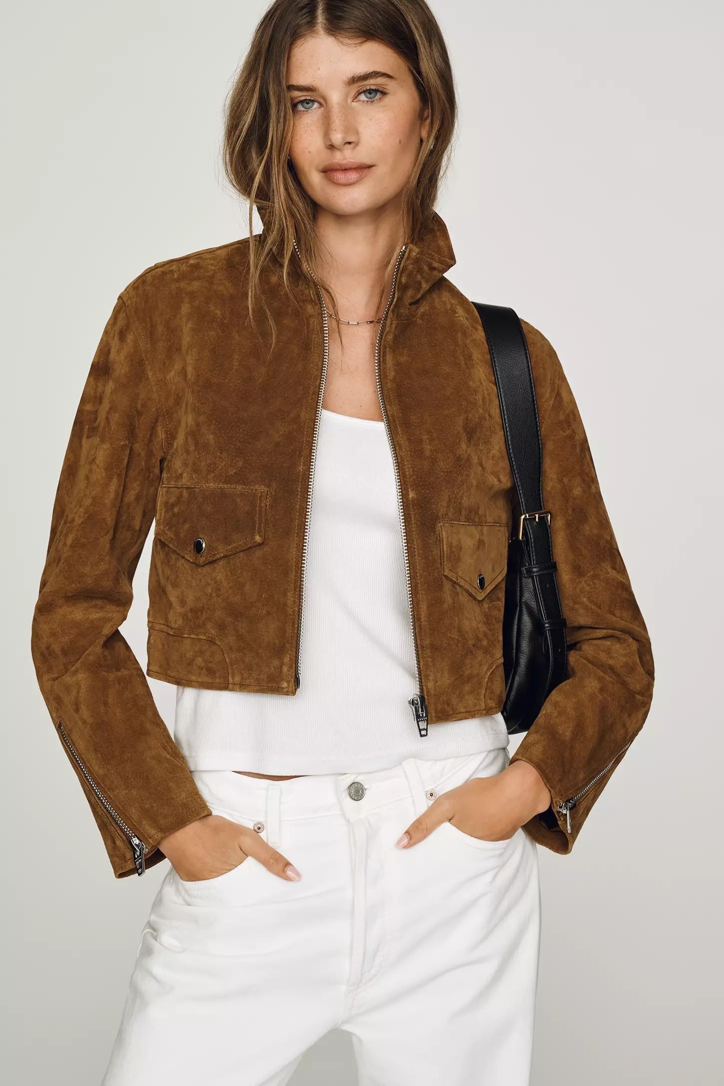 Longline suede jacket styled with boots and flared denim